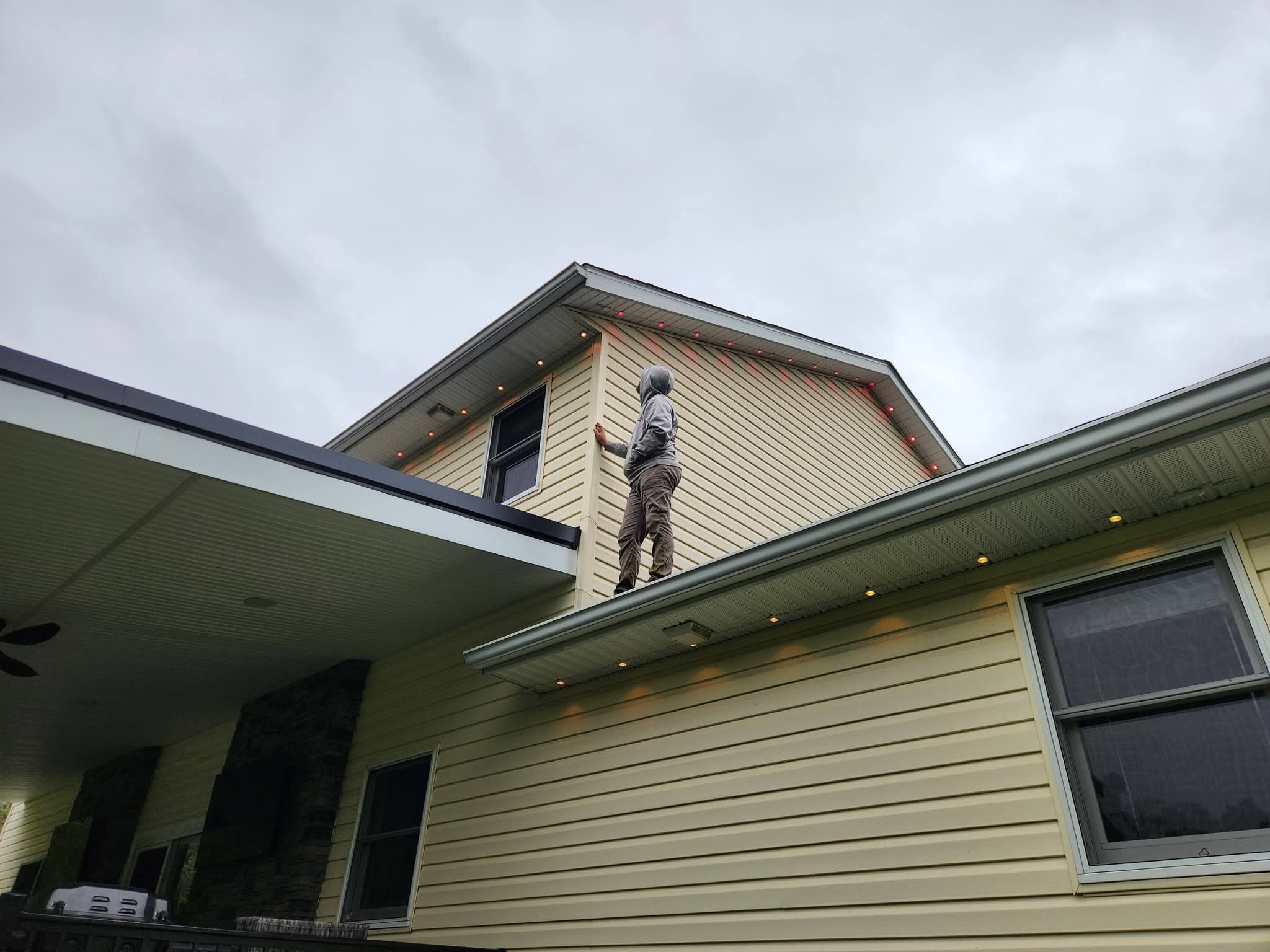 A crew member on the roof during a lighting install